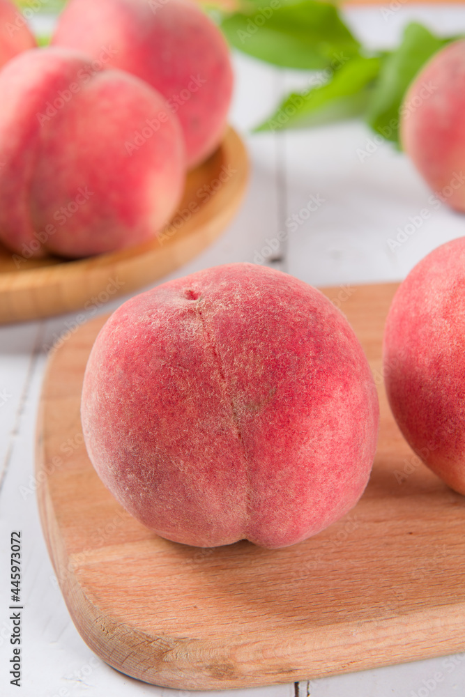 Ripe peach fruit close-up on wooden background