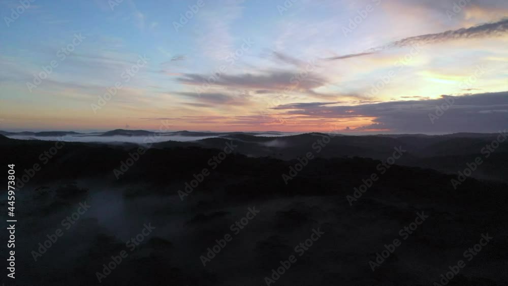 Aerial: Beautiful sunrise over a misty hilly landscape, in New South Wales, Australia Aerial: Beautiful sunrise over a misty hilly landscape, in New South Wales, Australia