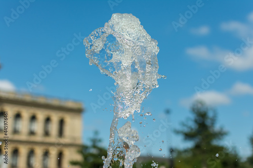 splashing water drops fountain on sky background