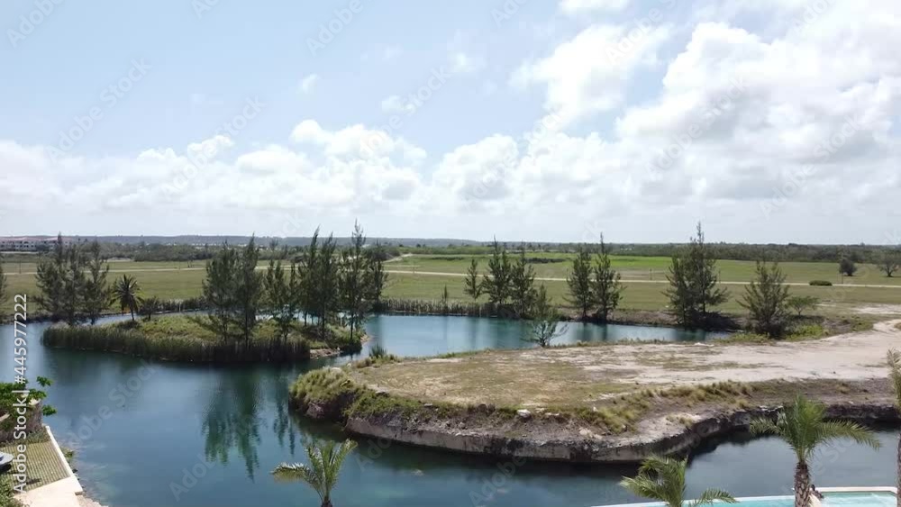 aerial shot of drone crossing between two residential buildings in punta cana, caribbean lifestyle, beautiful tropical ambiance aerial shot of drone crossing between two residential buildings in punta cana, caribbean lifestyle, beautiful tropical ambiance