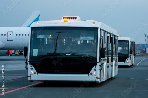 Two airport shuttle buses at the morning airfield photo