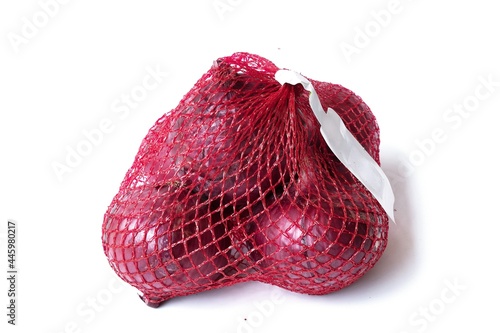 red onion in red packaging bag on white background