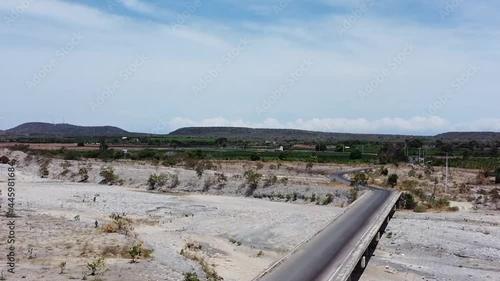 aerial shot of bridge in palmar de ocoa, old dry river on stones, old road not used, dominican republic
