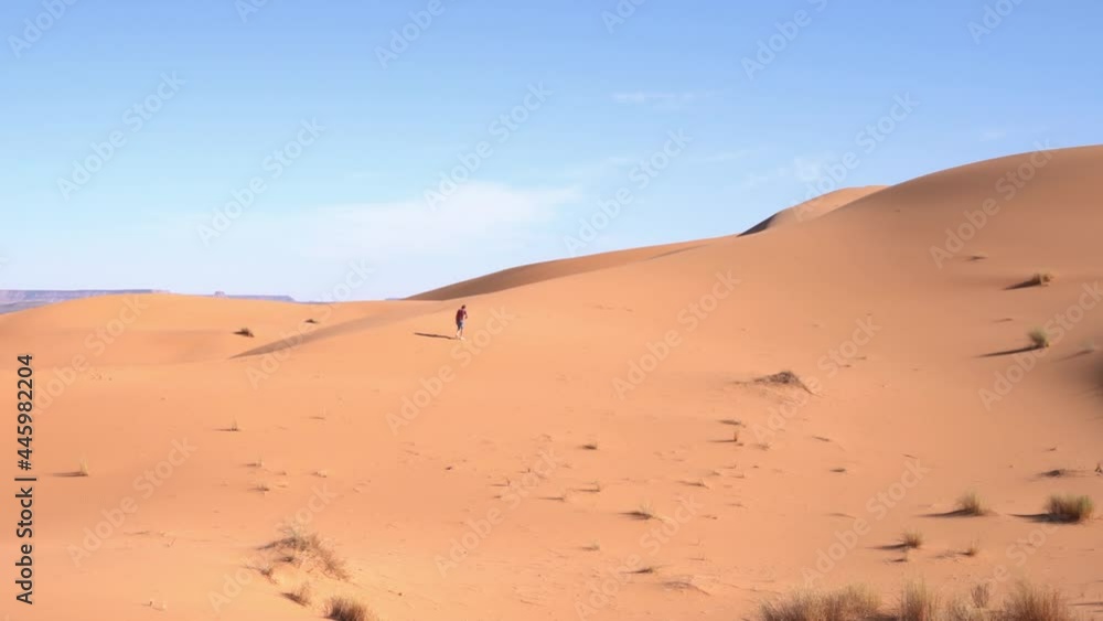 A Lonely Man in an Arid Desert Landscape on a Sunny Day, Static Shot A Lonely Man in an Arid Desert Landscape on a Sunny Day, Static Shot