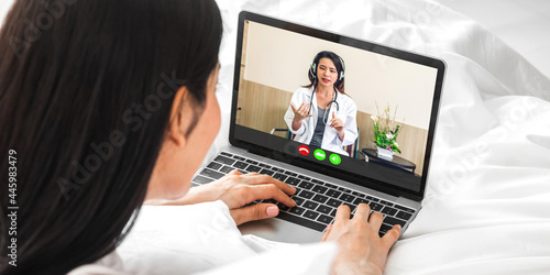 Woman talk speak using laptop computer and video conference online with doctor and stethoscope service help support team discussing and consulting talk video chat call checkup information at home