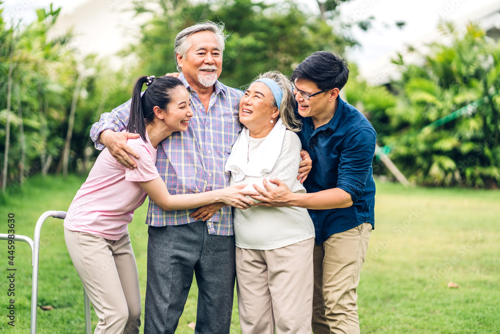 Portrait enjoy happy smiling love multi-generation asian big family.Senior mature father and elderly mother with young adult woman and son walking outdoor in park at home.insurance concept Portrait enjoy happy smiling love multi-generation asian big family.Senior mature father and elderly mother with young adult woman and son walking outdoor in park at home.insurance concept