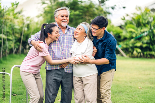Portrait enjoy happy smiling love multi-generation asian big family.Senior mature father and elderly mother with young adult woman and son walking outdoor in park at home.insurance concept © Art_Photo