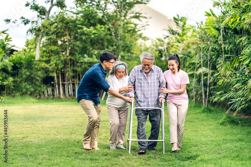 Portrait enjoy happy smiling love multi-generation asian big family.Senior mature father and elderly mother with young adult woman and son walking outdoor in park at home.insurance concept