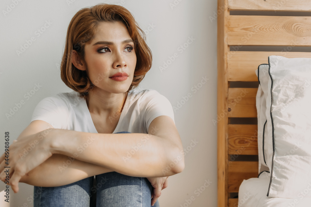 Cool looks of an Asian woman in a t-shirt and jeans relax in her apartment room. Cool looks of an Asian woman in a t-shirt and jeans relax in her apartment room.