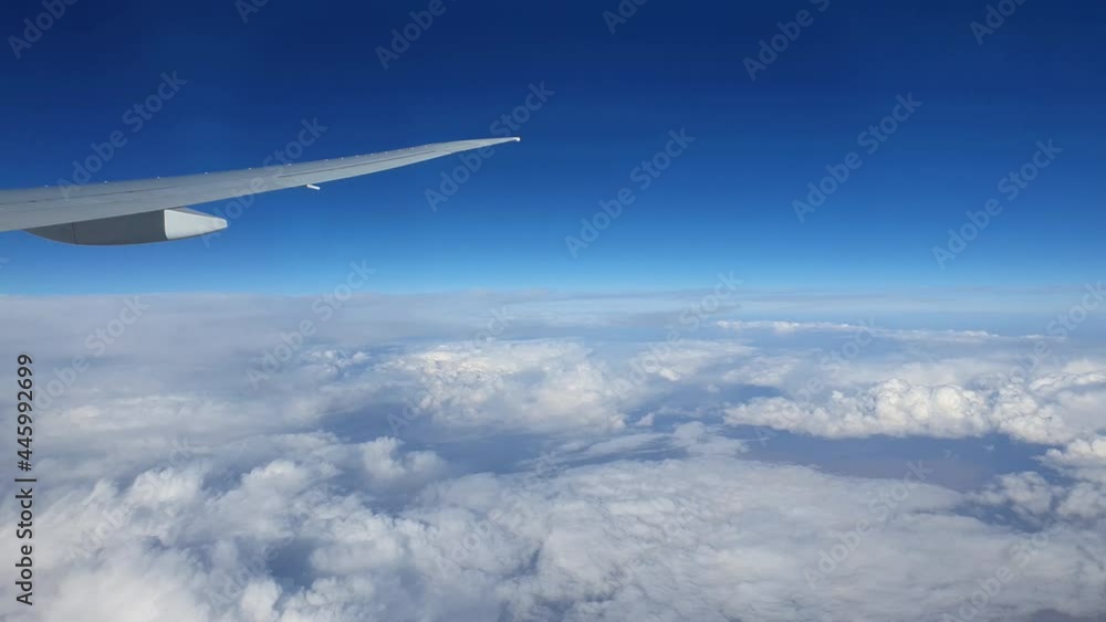 Wing of an airplane flying above the clouds. Wing of an airplane flying above the clouds.
