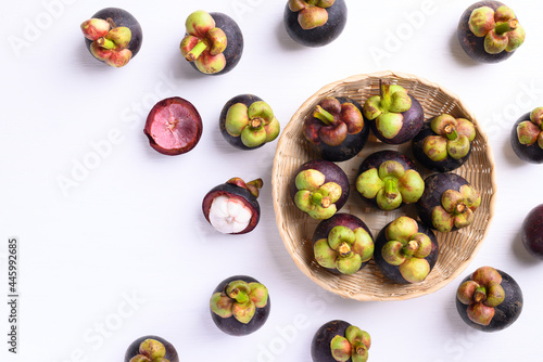 Mangosteen fruit in basket on white background, Flat lay, Tropical fruit