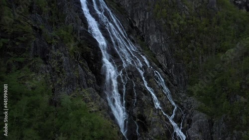 Slow descent drone shot of waterfall in Norway. photo