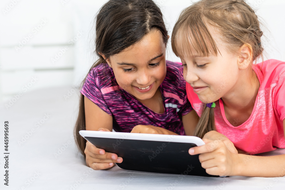 Little girls using tablet computer as art board - painting together Little girls using tablet computer as art board - painting together