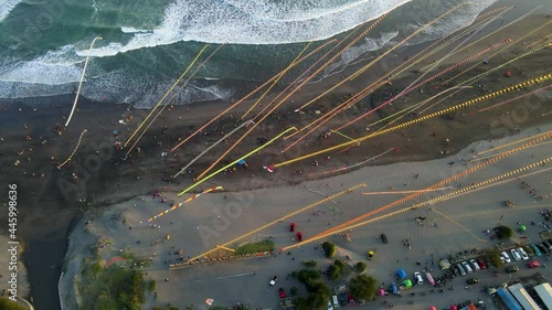 Long colourful kite tails on Parangkusumo beach on Jogja Festival, Indonesia  photo