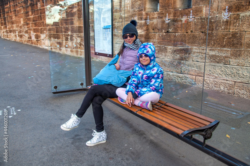 Canvas Print Mother and daughter relaxing on a bench in Sydney.