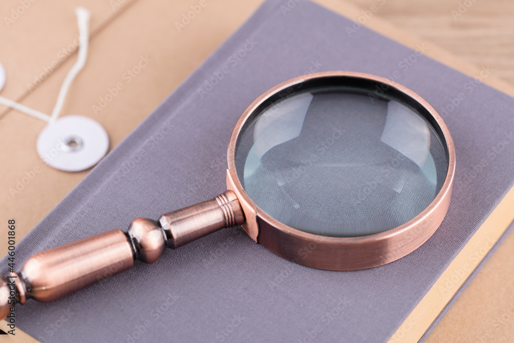 Magnifying glass on books books on paper bag Magnifying glass on books books on paper bag