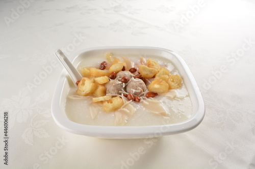 teo chew double boiled white rice ting zai porridge congee with meatball, you tiao, peanut and vegetable in square bowl asian dim sum menu photo