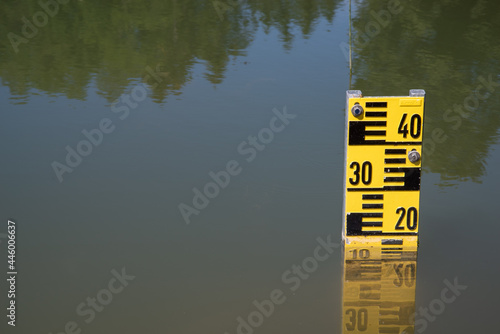 a pond with a measuring tool