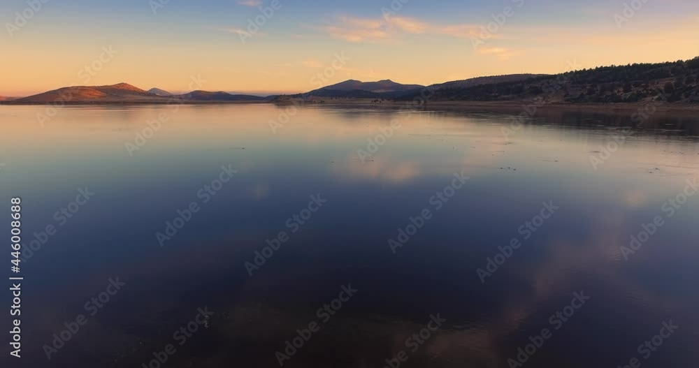 Aerial flying over a lake of migrating birds at sunset in Northern California Aerial flying over a lake of migrating birds at sunset in Northern California