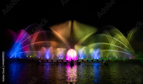 colorful fountain dancing in celebration of year with dark night sky background. © APchanel