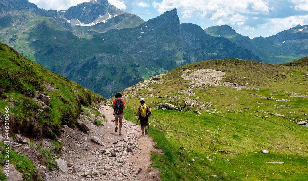 Two hiker women in path of Pic du Midi Ossau in French Pyrenees mountains
