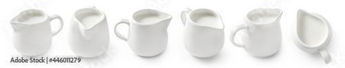 Set of porcelain milk jars isolated on white background. Milk pitchers for package design. Collection of ceramic milk creamers on white. Top view of milk.