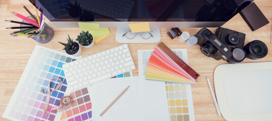Top View of creative table with large desktop computer. working Place for graphic design..