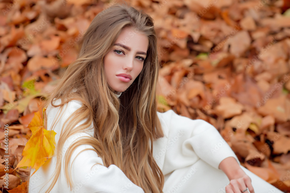 Autumn, beautiful girl in maple, yellow leaves.
