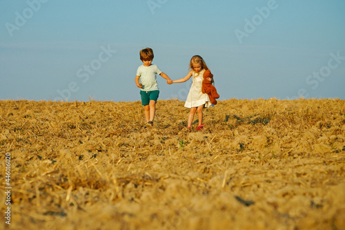 Beautiful fun day for cute friends in nature. Children has summer joy. Children play outdoors. While having fun outdoors. Positive little girl and boy. Little kid outdoor.