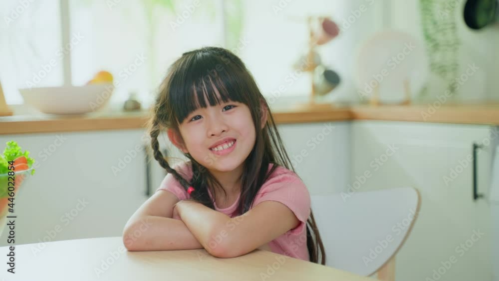 Portrait of Asian young little kid smile and look at camera in kitchen Portrait of Asian young little kid smile and look at camera in kitchen