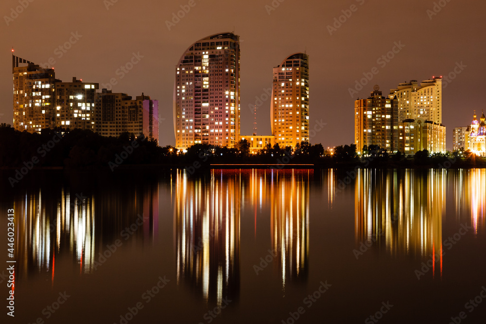 night city with reflection of houses in the river