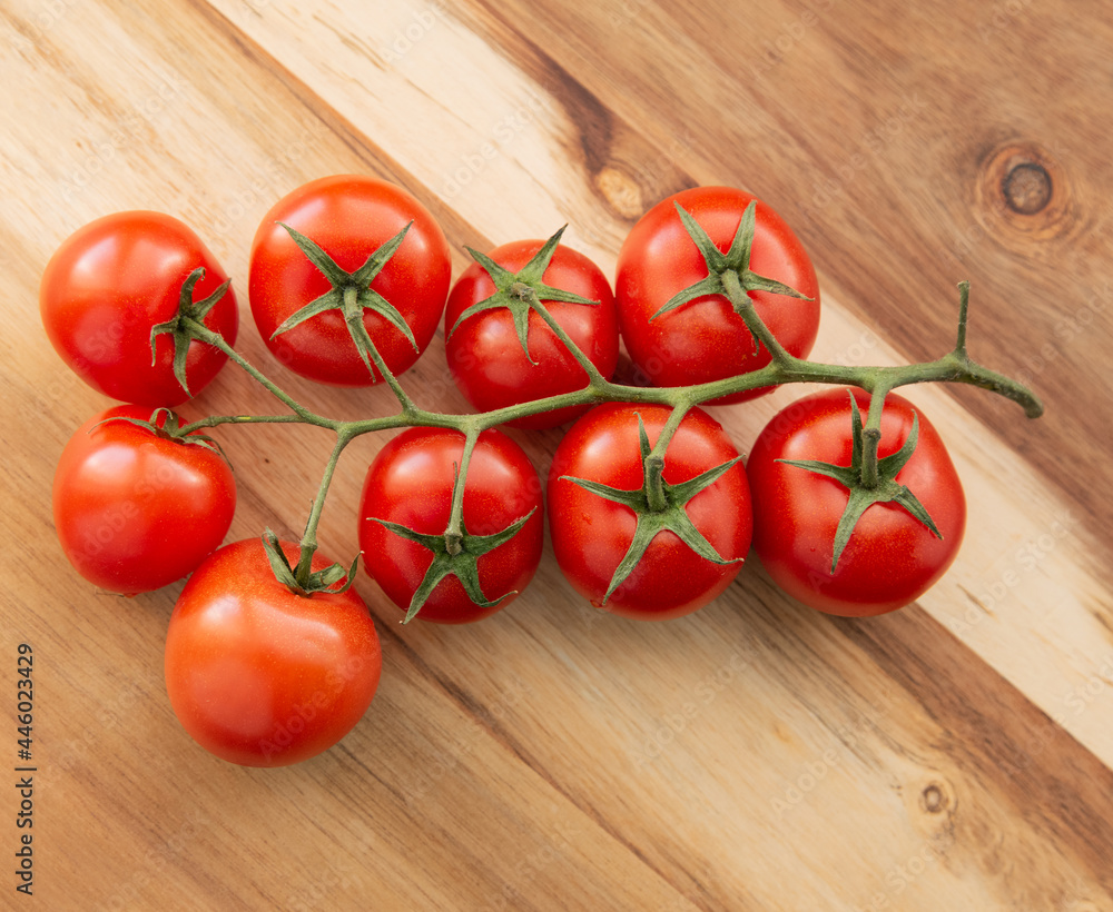 Natural-looking tomatoes on wooden background. Selective focus. Natural-looking tomatoes on wooden background. Selective focus.