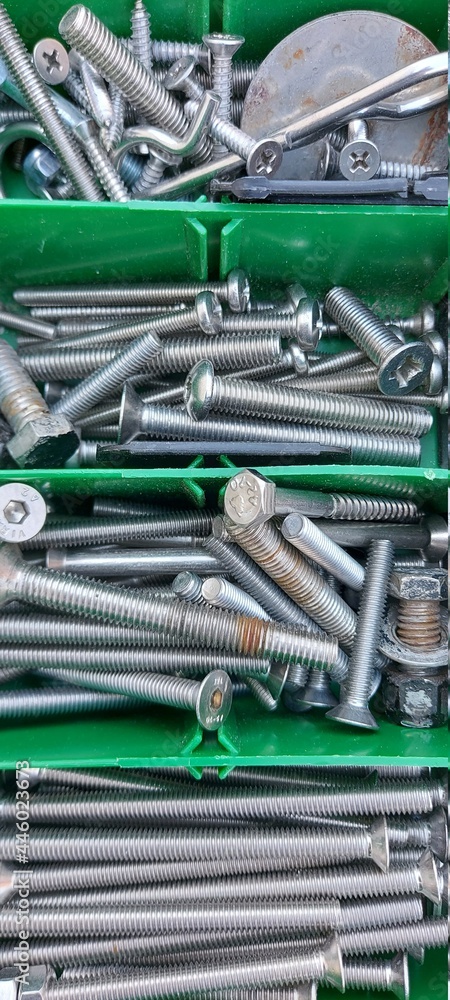Renovation and construction: bolts and nuts of different sizes close-up.