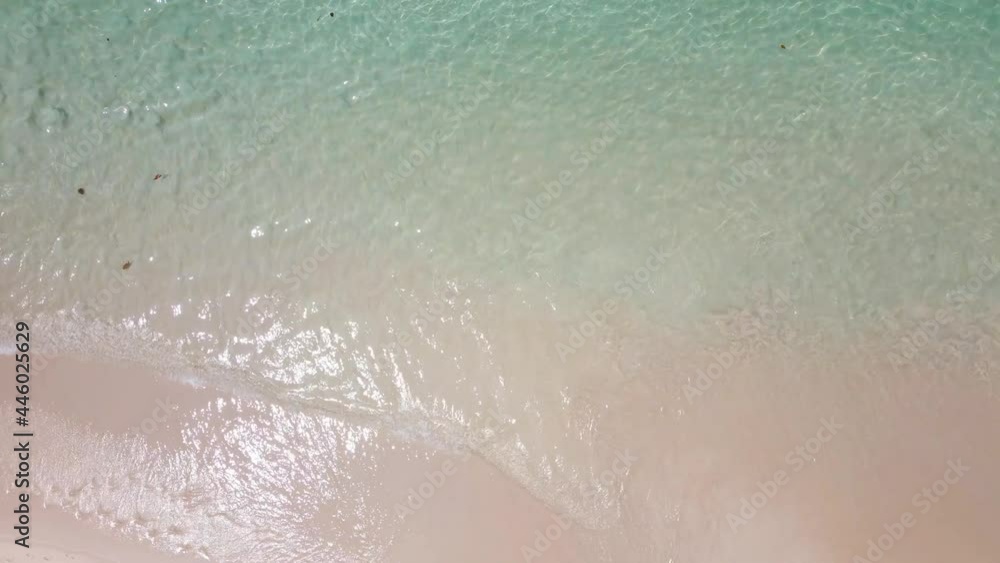 Aerial view shot of drone. Top-down view full frame beach sand and water texture and clear. Nature and travel concept. 4K UHD Video clip. Aerial view shot of drone. Top-down view full frame beach sand and water texture and clear. Nature and travel concept. 4K UHD Video clip.