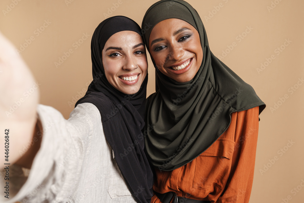 Young muslim women in hijab smiling while taking selfie photo