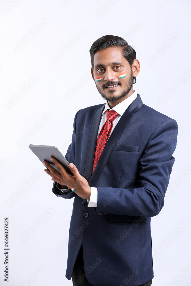 Young indian businessman using tablet over white background. Young indian businessman using tablet over white background.