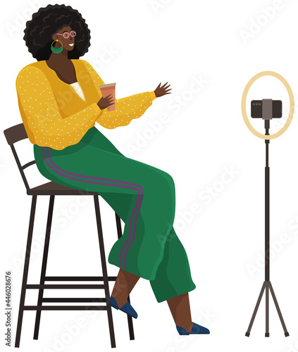 Woman is recording video on smartphone. African american girl is broadcasting live, podcasting using phone. Record video, live online podcast. Female blogger broadcasting, recording video blog