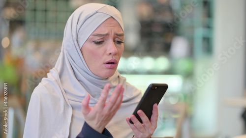 Portrait of Young Arab Woman having Loss on Smartphone 