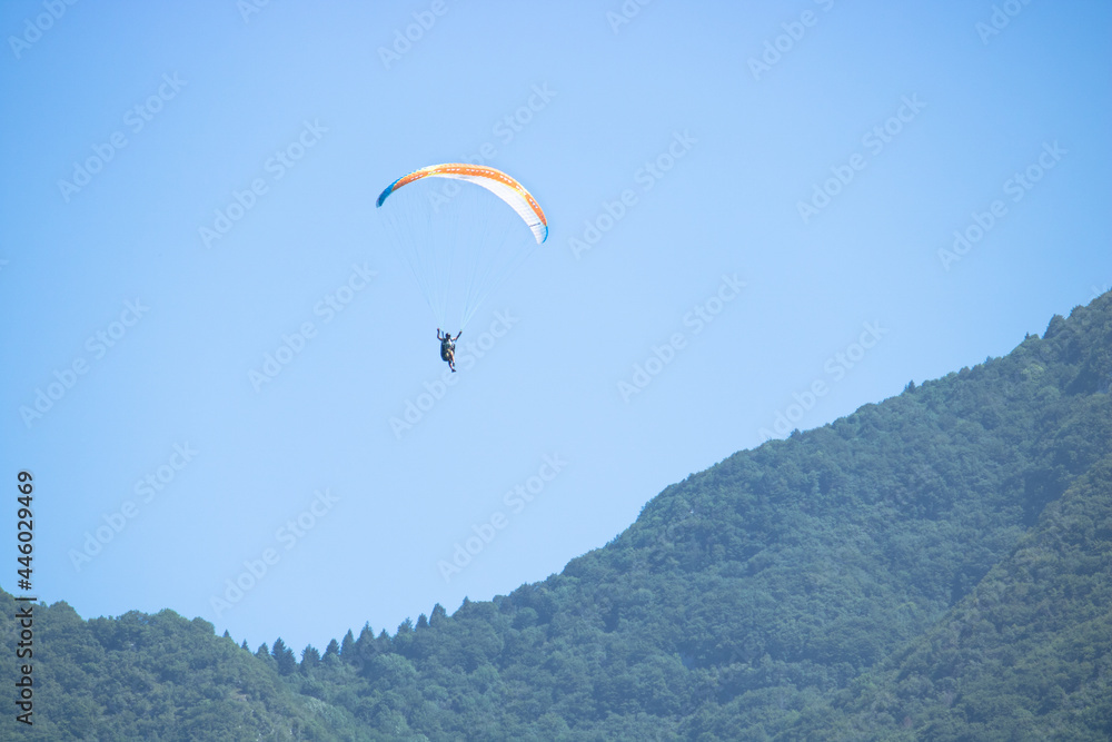 paraglide flying on the sky. paragliding on mountain background
