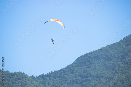 paraglide flying on the sky. paragliding on mountain background