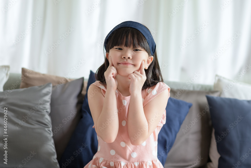 Portrait of asian little cute girl with happy charming smile in living room at home. Portrait of asian little cute girl with happy charming smile in living room at home.