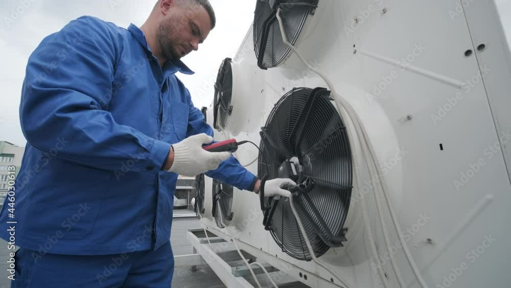 Testing with an anemometer of an axial fan of the condensing unit Testing with an anemometer of an axial fan of the condensing unit