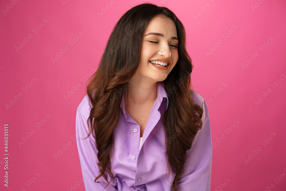 Young happy woman smiling over pink background Young happy woman smiling over pink background