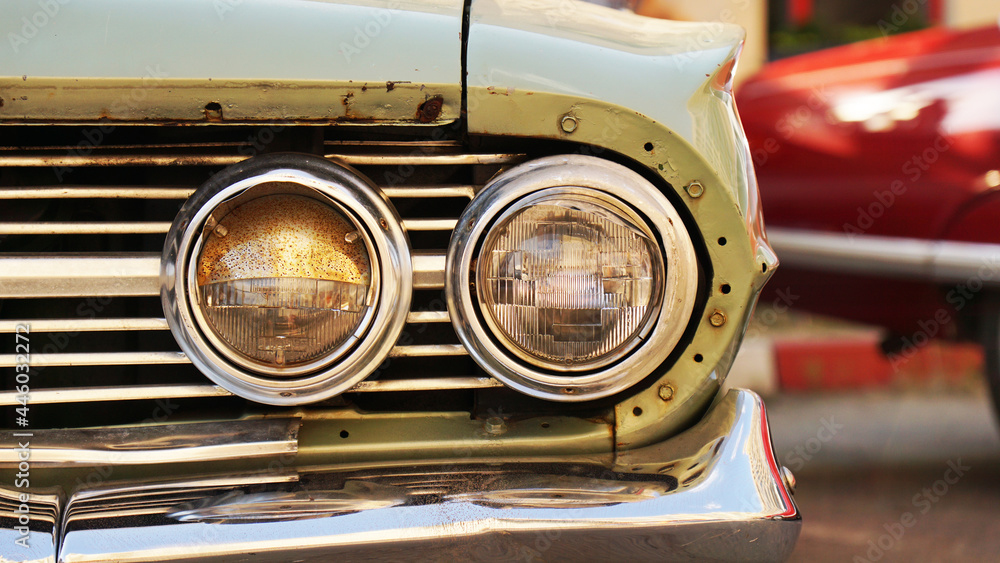 Retro car. Old vintage car. Headlight close up. Exhibition of retro car.