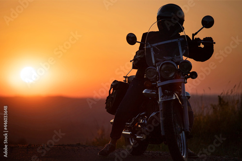 Driver riding motorcycle on an empty road