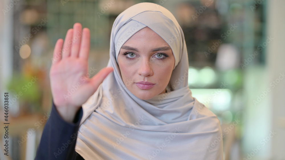 Portrait of Assertive Arab Woman showing Stop Sign by Hand Portrait of Assertive Arab Woman showing Stop Sign by Hand