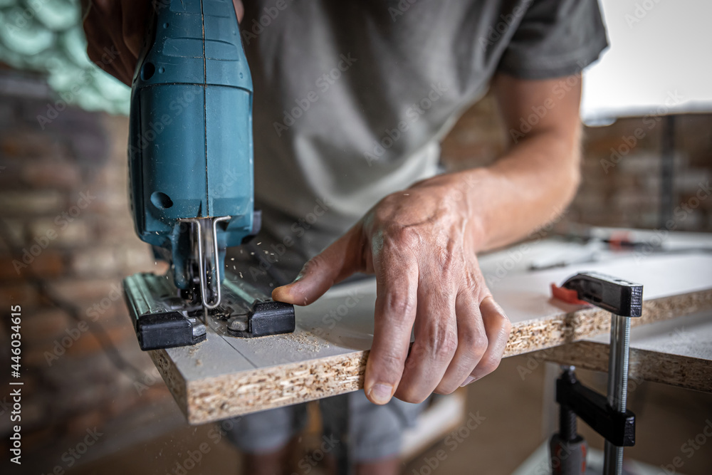 Close-up process of cutting wood board with jigsaw. Close-up process of cutting wood board with jigsaw.