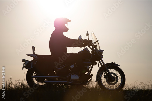 Driver riding motorcycle on an empty road