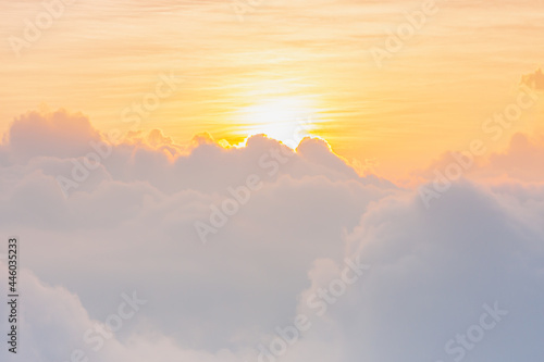 beautiful yellow sunlight of sun while sunrise or sunset with soft white cloud on sky for wallpaper or background