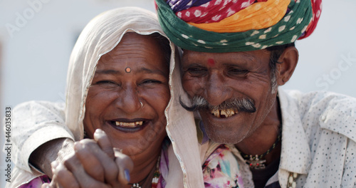 Smiling authentic South Asian elder couple in traditional clothing photo